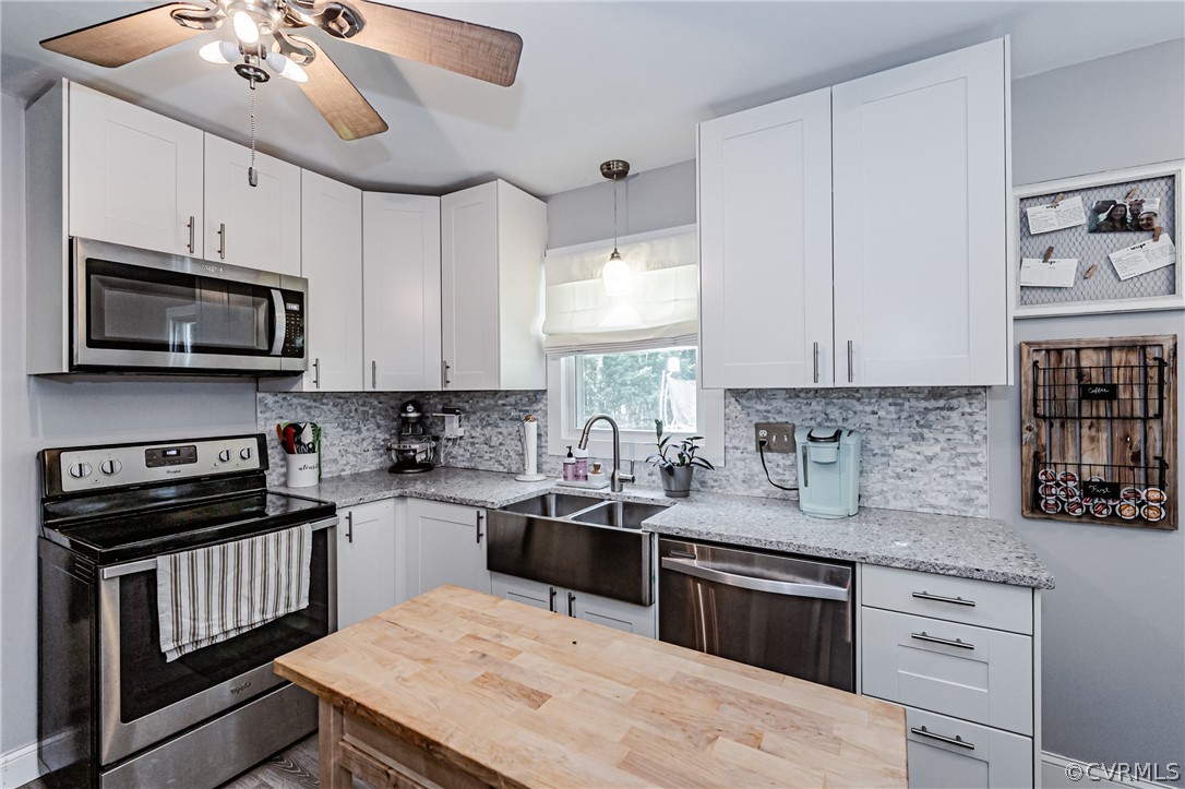 5018 Rollingway Road Chesterfield, VA 23832 - Photo 20 of 49 a kitchen with granite countertop a sink a stove and microwave