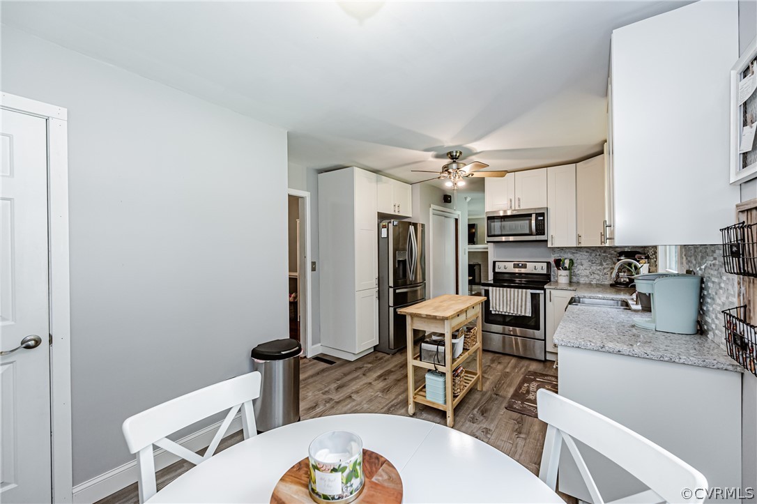 5018 Rollingway Road Chesterfield, VA 23832 - Photo 21 of 49 a kitchen with stainless steel appliances kitchen island granite countertop a dining table chairs and granite counter tops