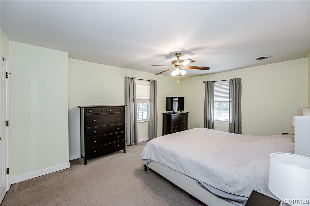 5018 Rollingway Road Chesterfield, VA 23832 - Photo 31 of 49 a spacious bedroom with a bed and a chandelier