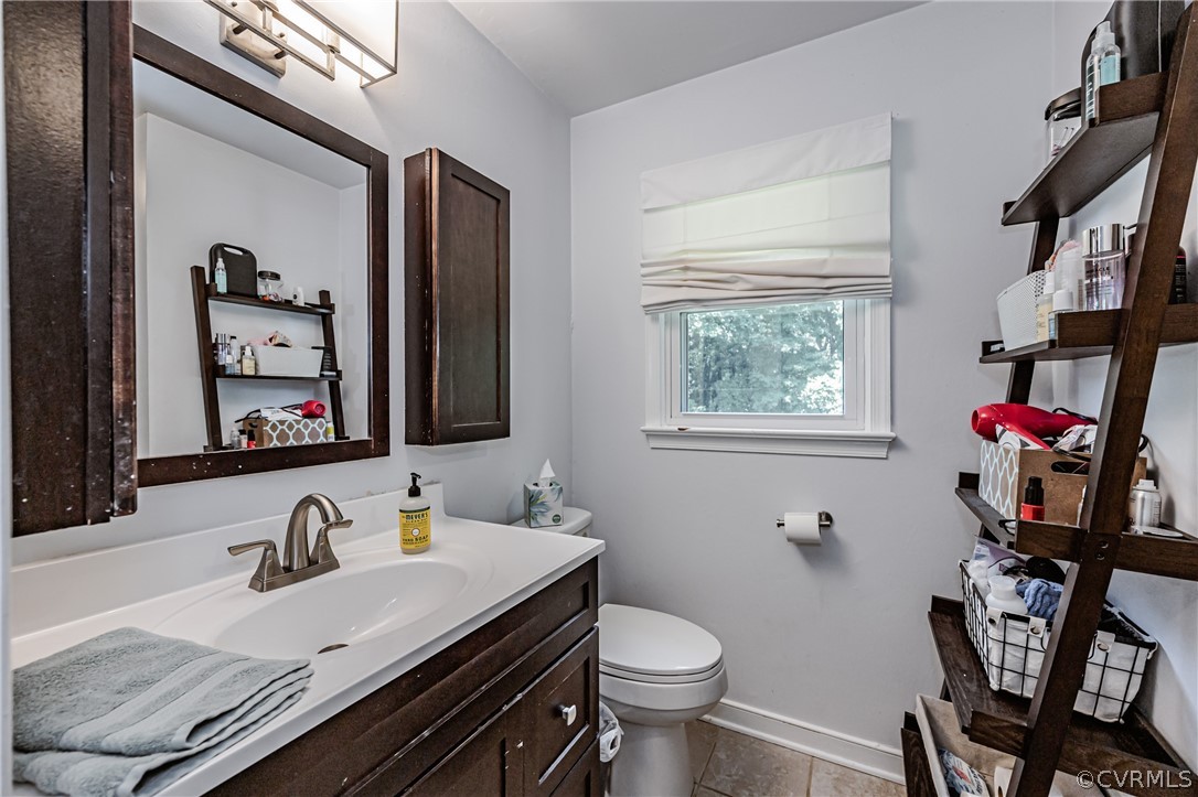 5018 Rollingway Road Chesterfield, VA 23832 - Photo 33 of 49 a bathroom with a granite countertop double vanity sink a mirror and a window