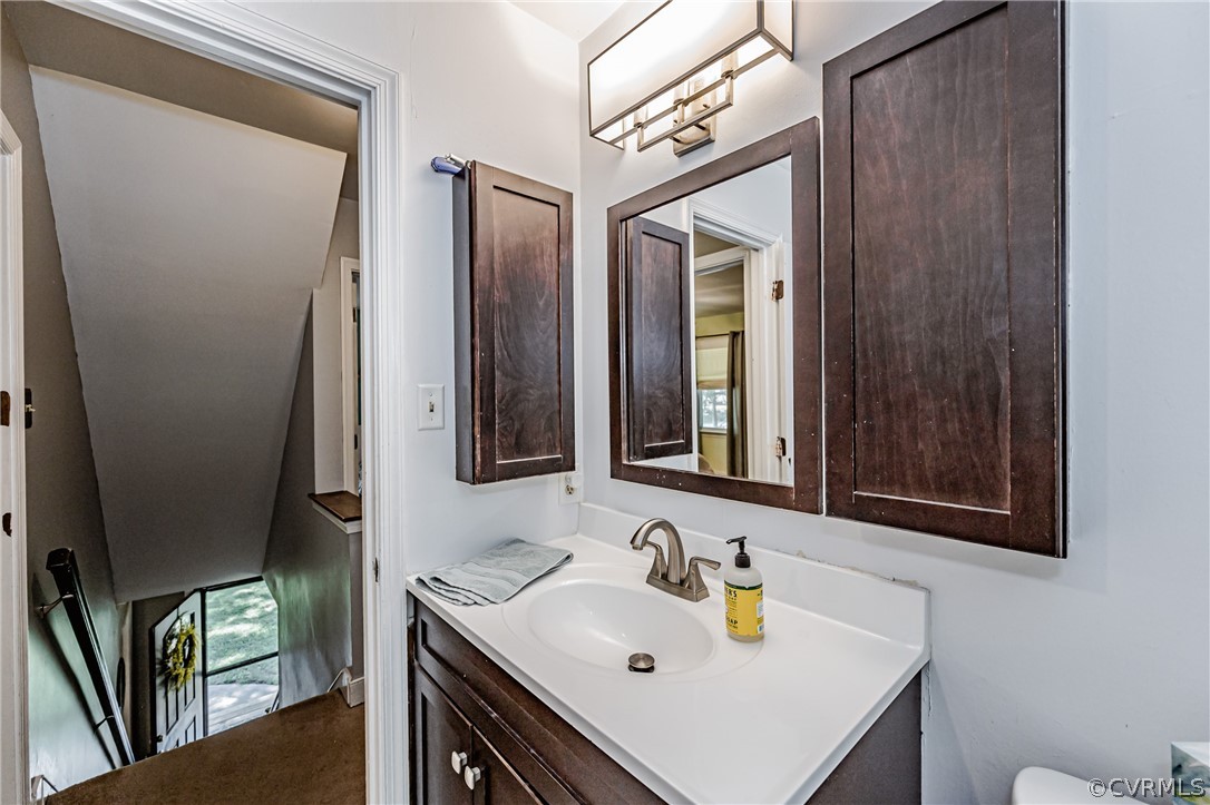 5018 Rollingway Road Chesterfield, VA 23832 - Photo 35 of 49 a bathroom with a sink a mirror and shower