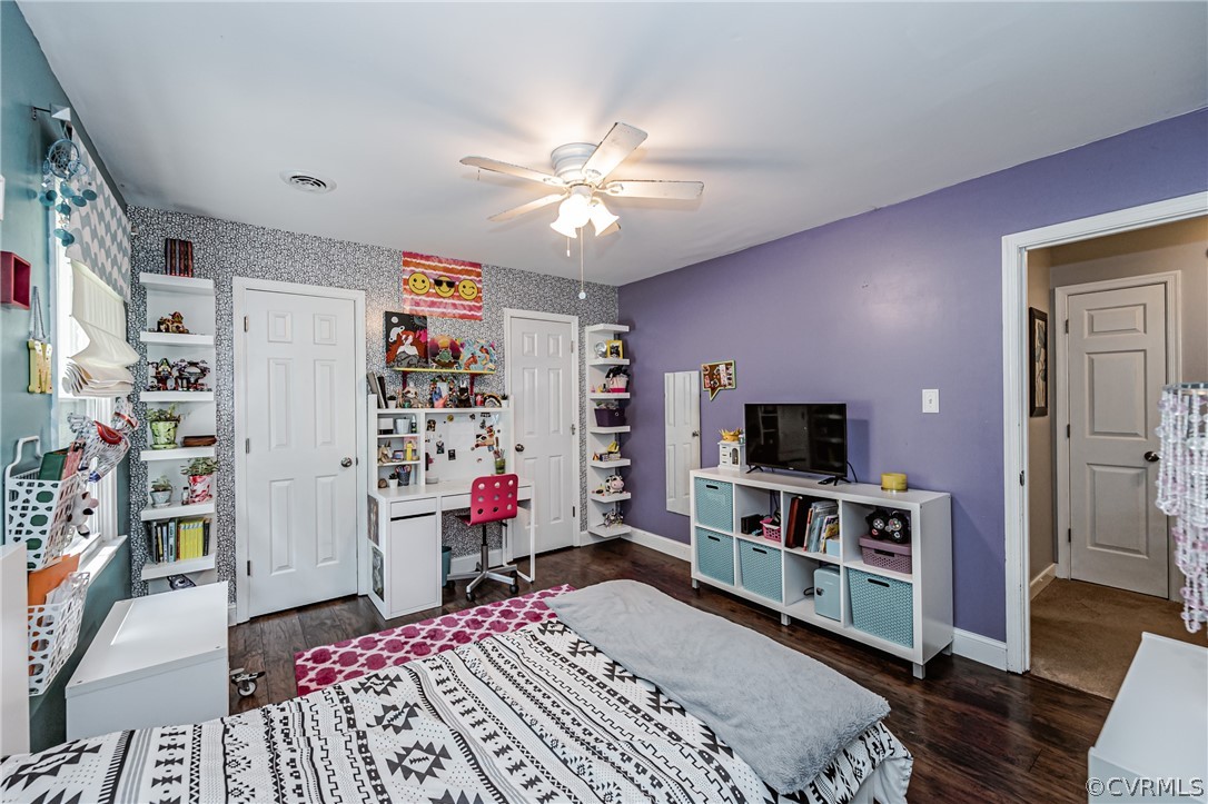 5018 Rollingway Road Chesterfield, VA 23832 - Photo 40 of 49 a bed room with a bed a flat screen tv and a book shelf