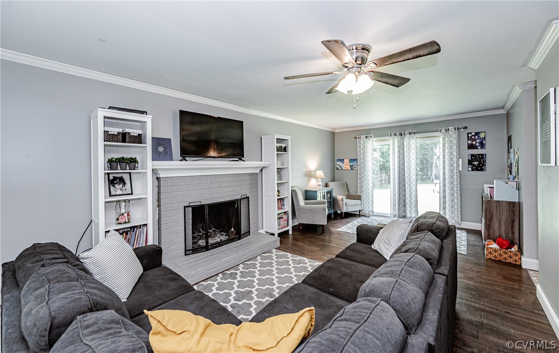5018 Rollingway Road Chesterfield, VA 23832 - Photo 10 of 49 a living room with furniture a flat screen tv and a fireplace