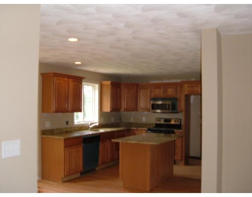 Lot 4 John Riley Road Ayer, MA 01432 - Photo 4 of 4 a kitchen with kitchen island granite countertop a sink cabinets and stainless steel appliances