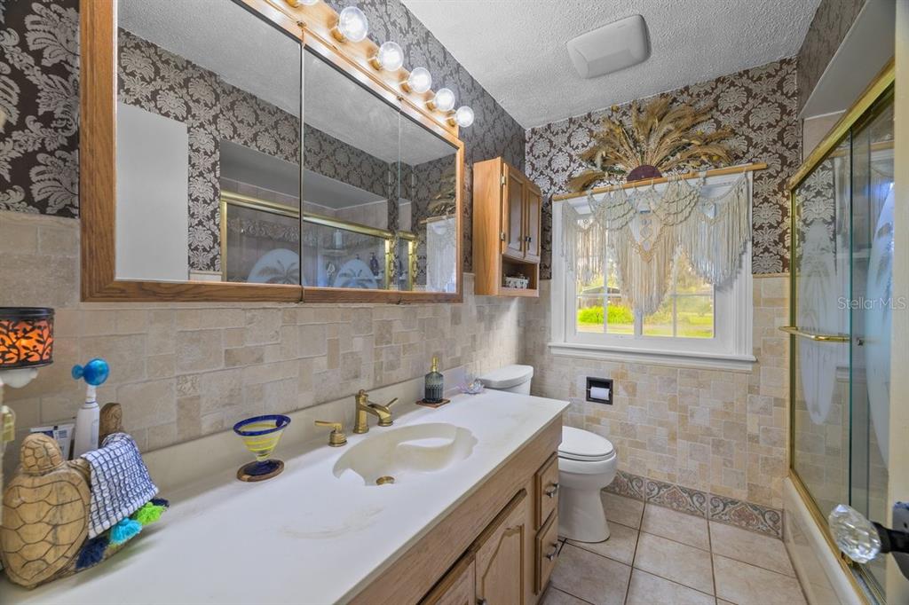 101 Orange Street Satsuma, FL 32189 - Photo 15 of 65 a bathroom with a sink mirror and shower