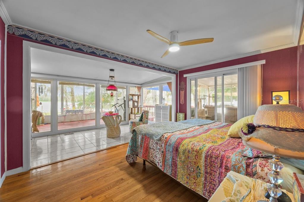101 Orange Street Satsuma, FL 32189 - Photo 16 of 65 a bedroom with a large bed and wooden floor