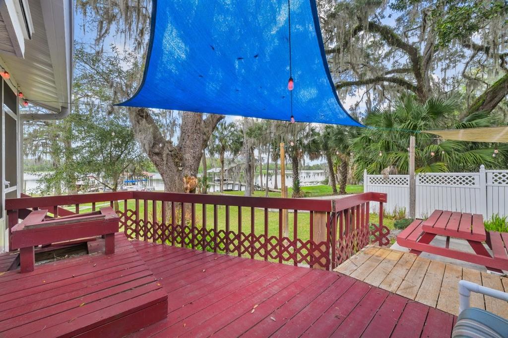101 Orange Street Satsuma, FL 32189 - Photo 19 of 65 a view of deck with wooden floor and outdoor seating