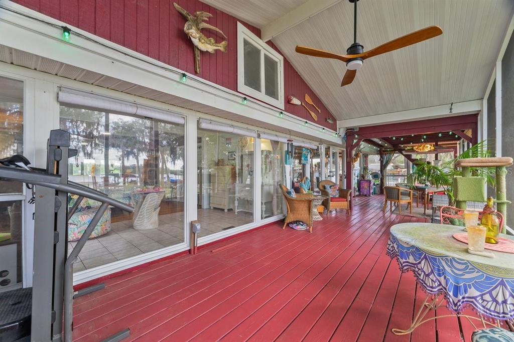 101 Orange Street Satsuma, FL 32189 - Photo 23 of 65 a view of a patio with a table chairs and wooden floor