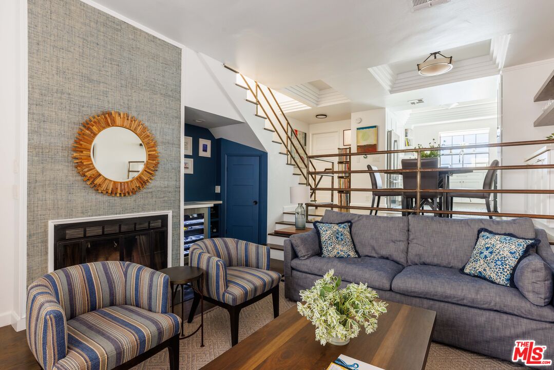 36 Navy Street, Unit 4 Venice, CA 90291 - Photo 1 of 37 a living room with furniture a fireplace and a large window