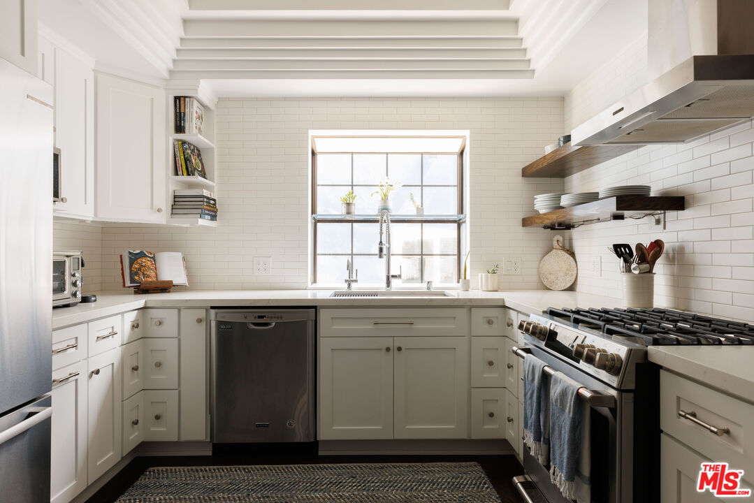 36 Navy Street, Unit 4 Venice, CA 90291 - Photo 11 of 37 a kitchen with stainless steel appliances granite countertop a sink and a stove