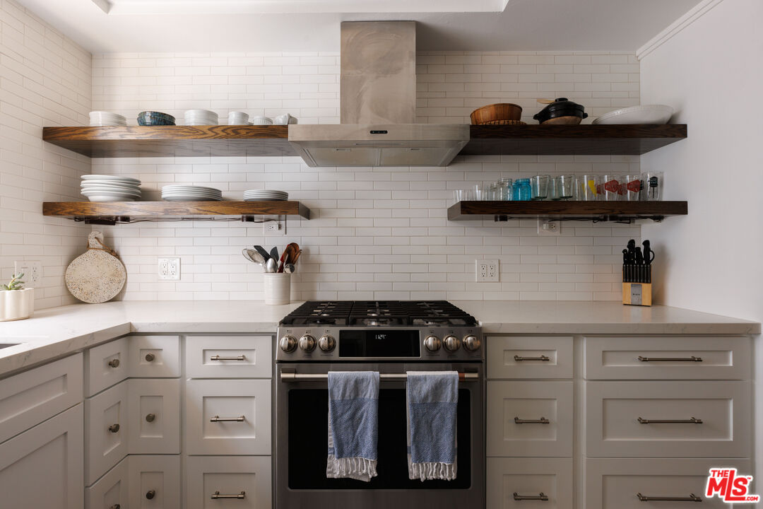 36 Navy Street, Unit 4 Venice, CA 90291 - Photo 12 of 37 a kitchen with white cabinets and stove top oven
