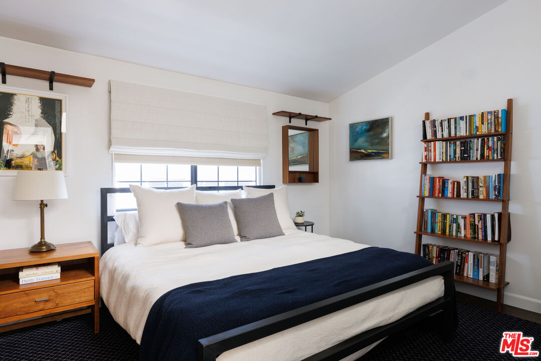 36 Navy Street, Unit 4 Venice, CA 90291 - Photo 28 of 37 a bedroom with a bed and a book shelf