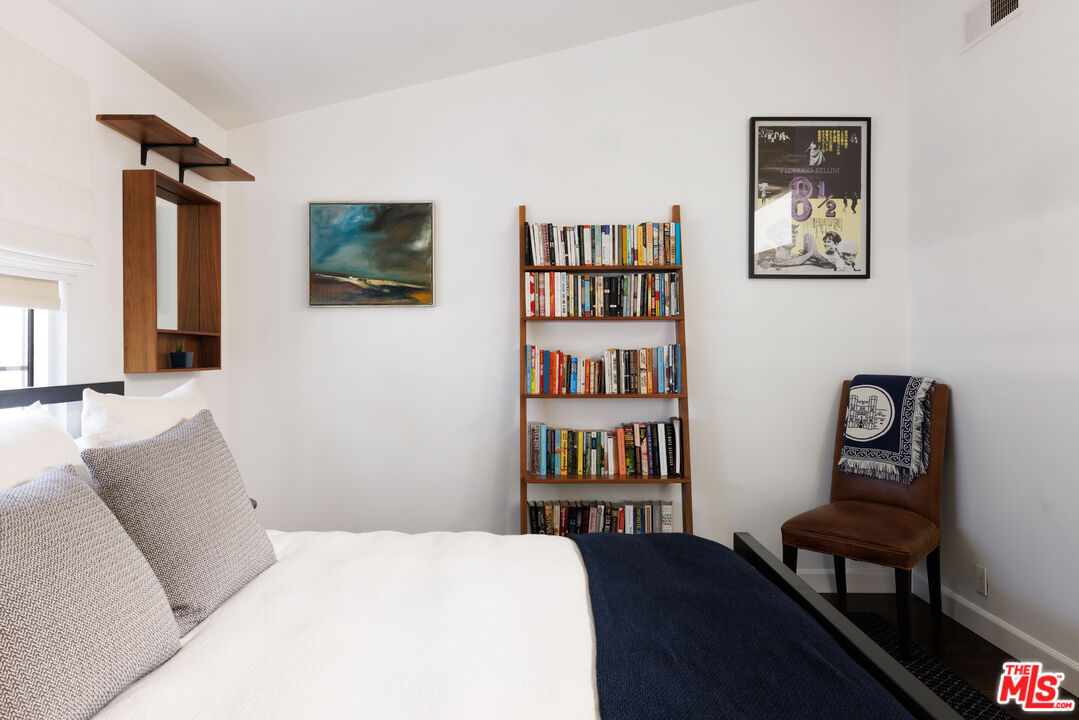 36 Navy Street, Unit 4 Venice, CA 90291 - Photo 30 of 37 a bedroom with a bed and a bookshelf