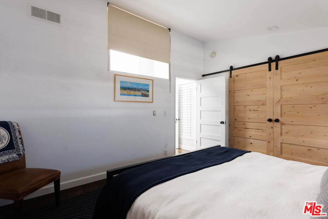 36 Navy Street, Unit 4 Venice, CA 90291 - Photo 31 of 37 a bedroom with a bed and a window