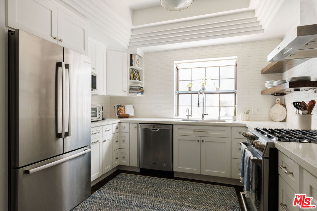 36 Navy Street, Unit 4 Venice, CA 90291 - Photo 10 of 37 a kitchen with stainless steel appliances a refrigerator sink and white cabinets