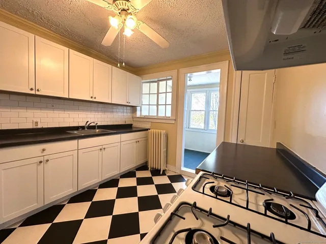 a kitchen with a sink a stove and a microwave