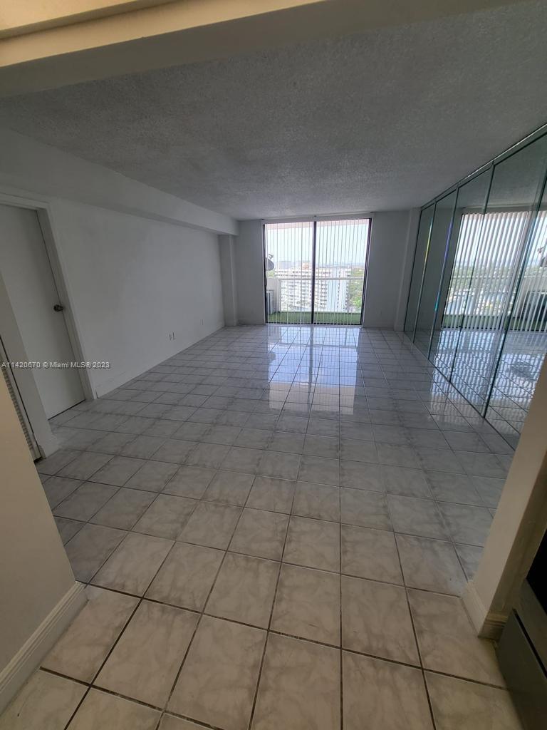 13499 Biscayne Boulevard, Unit 1204 North Miami, FL 33181 - Photo 12 of 14 a view of an empty room and glass door
