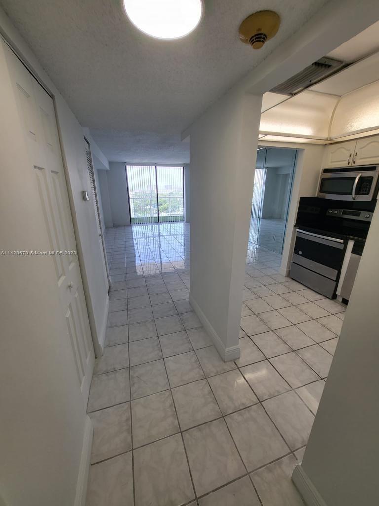 13499 Biscayne Boulevard, Unit 1204 North Miami, FL 33181 - Photo 5 of 14 a view of a livingroom with an oven