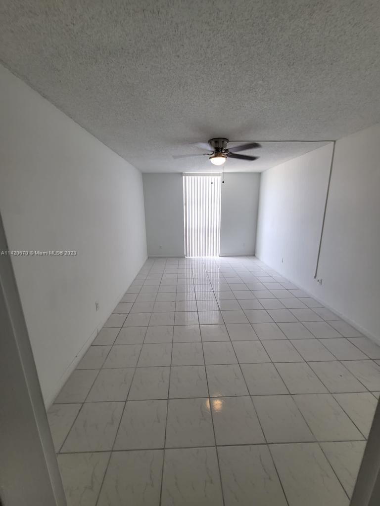 13499 Biscayne Boulevard, Unit 1204 North Miami, FL 33181 - Photo 7 of 14 a view of a livingroom and a hallway