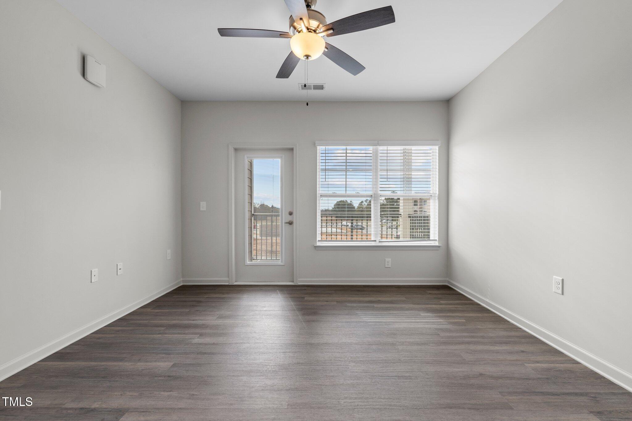 170 Grove Circle, Unit 302 Lillington, NC 27546 - Photo 11 of 28 wooden floor in an empty room with a window