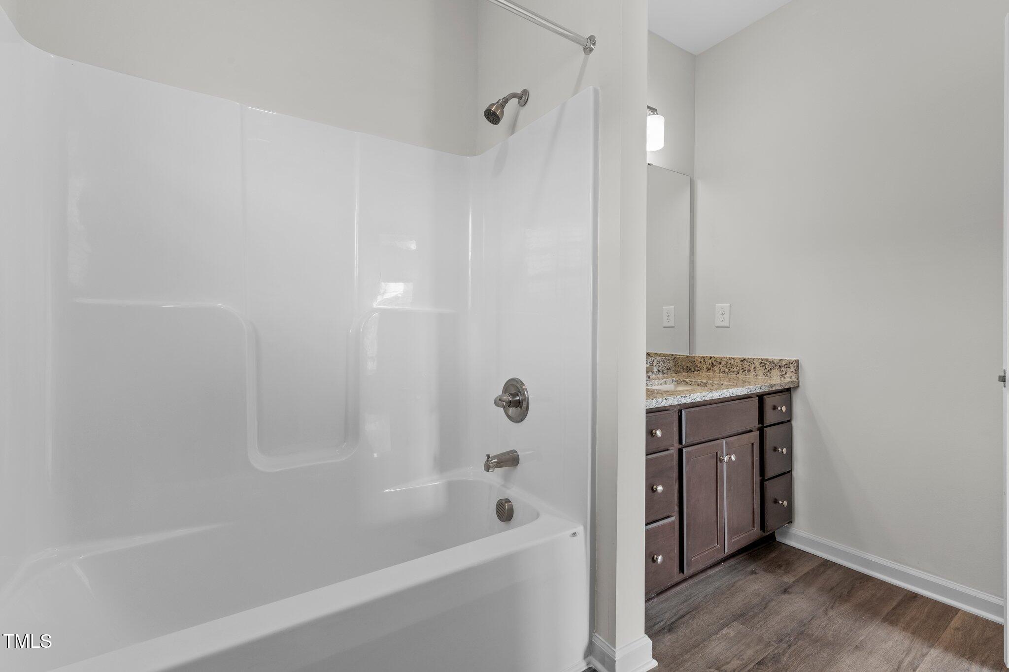 170 Grove Circle, Unit 302 Lillington, NC 27546 - Photo 17 of 28 a bathroom with a bathtub and a shower