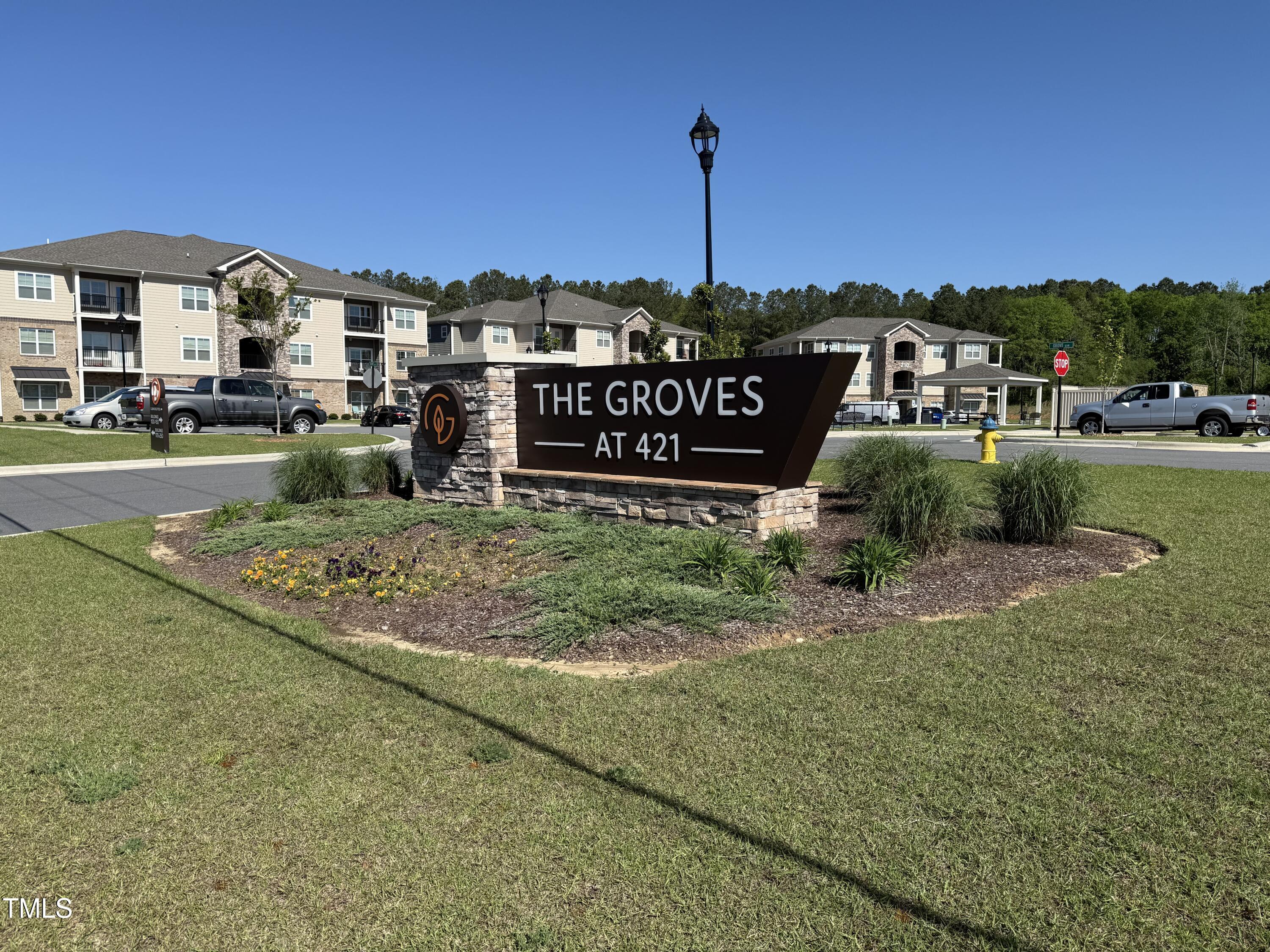 170 Grove Circle, Unit 302 Lillington, NC 27546 - Photo 25 of 28 a front view of a house with garden