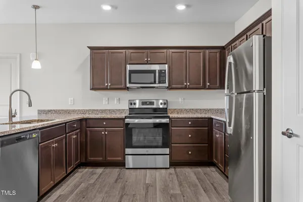 a kitchen with a sink stove and microwave