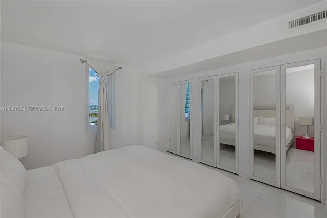 a bedroom with a bed and a view of bathroom