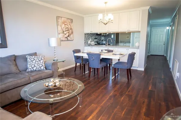 a dining room with furniture a rug and wooden floor