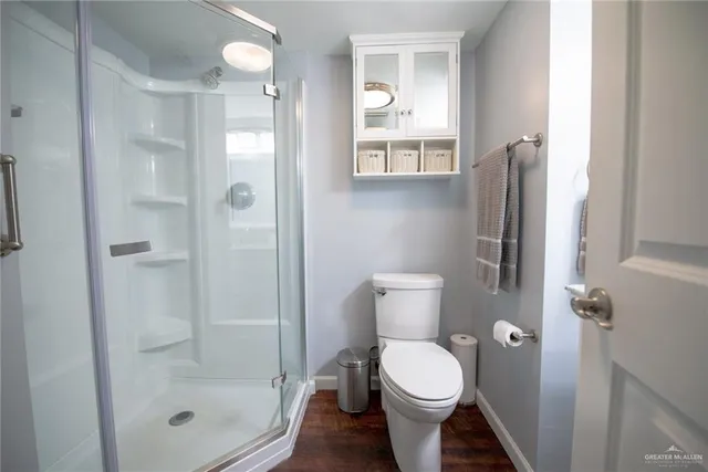 a bathroom with a toilet and shower