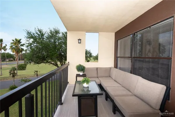 a balcony with furniture and a potted plant