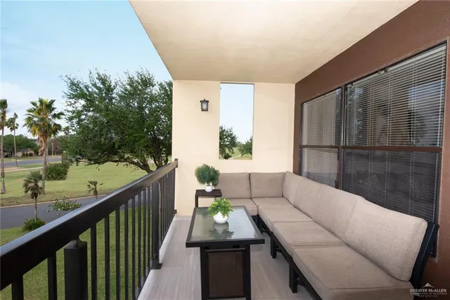 a balcony with furniture and a potted plant
