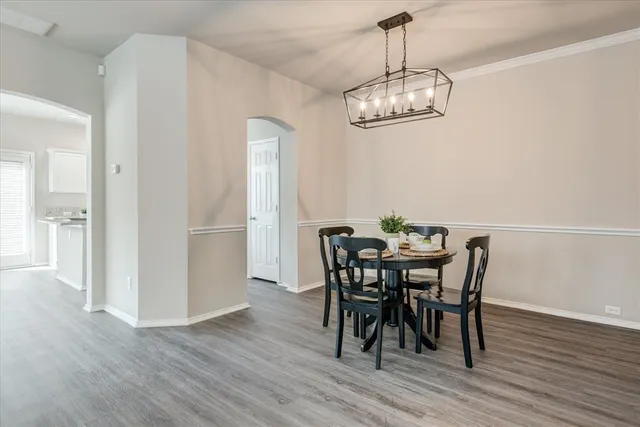 a view of a dining room with furniture and wooden floor
