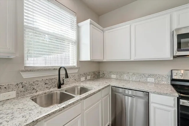 a kitchen with sink cabinets and window