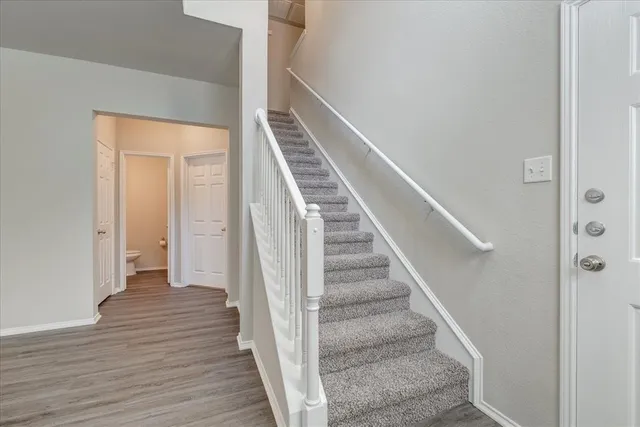 a view of an entryway with wooden floor