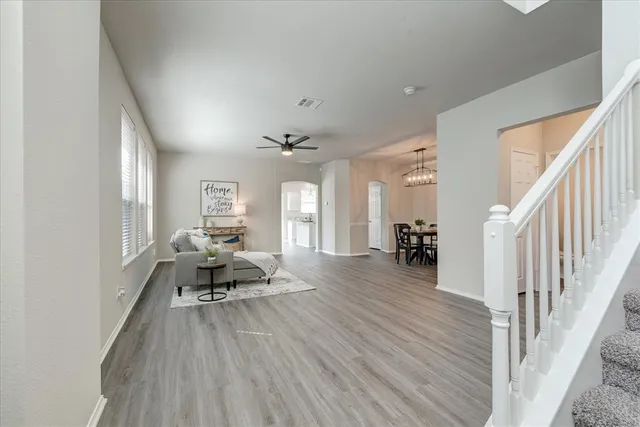 a living room with furniture and wooden floor