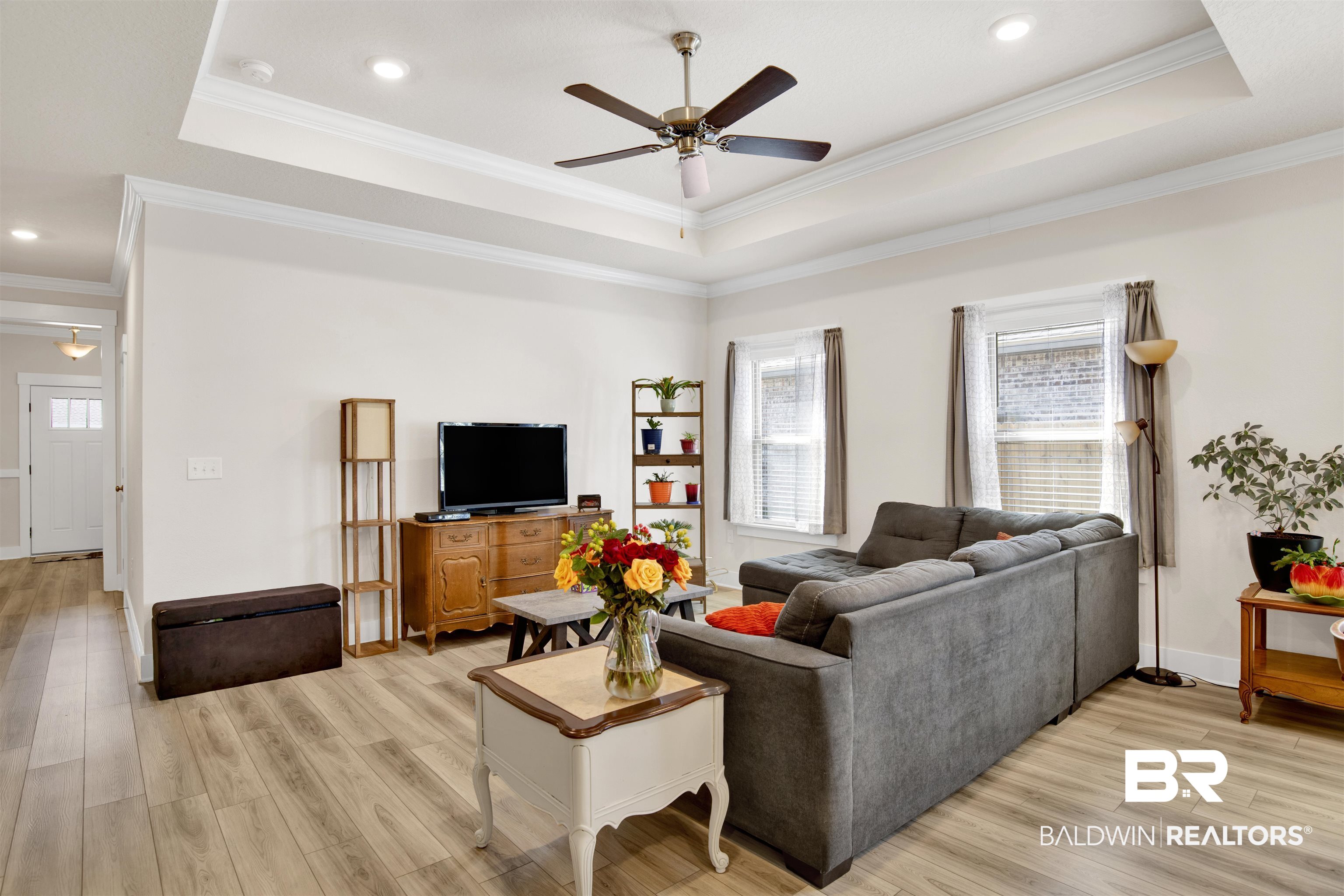 1174 Pheasant Circle Foley, AL 36535 - Photo 8 of 29 Living area with a ceiling fan, light wood finished floors, crown molding, recessed lighting, and a raised ceiling