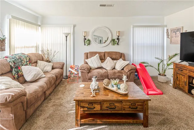 a living room with furniture a flat screen tv and a floor