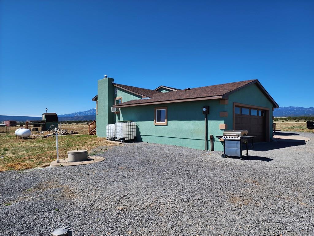 6023 South Waterbarrel Road Beulah, CO 81023 - Photo 4 of 63 a front view of a house with a yard