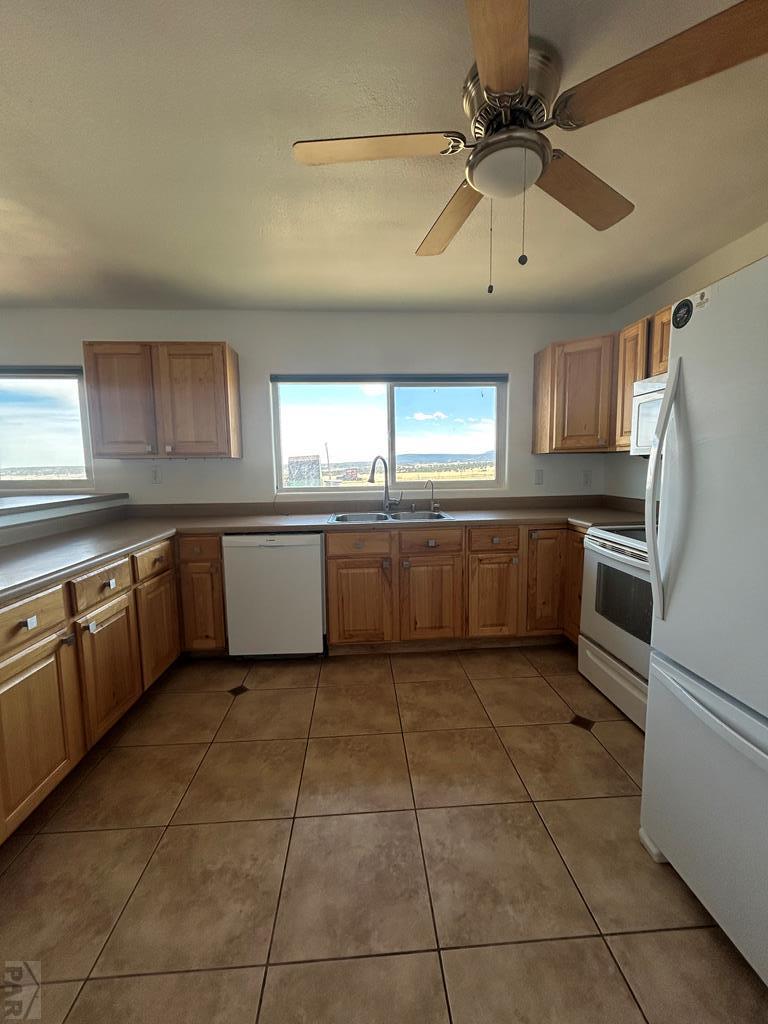 6023 South Waterbarrel Road Beulah, CO 81023 - Photo 44 of 63 a kitchen with granite countertop a refrigerator and a stove top oven