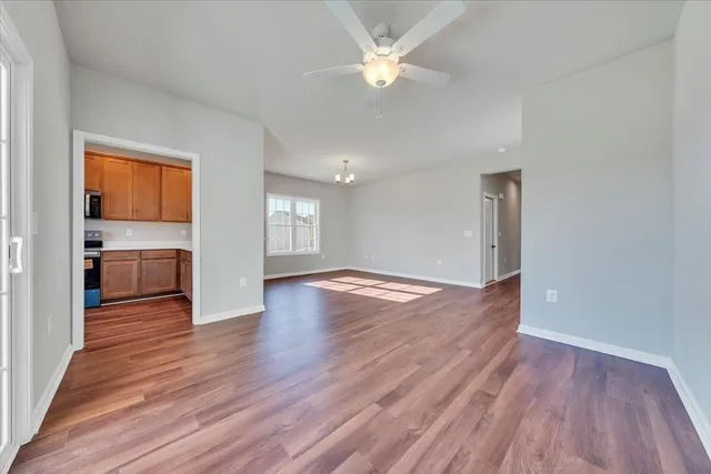 wooden floor in an empty room with a window