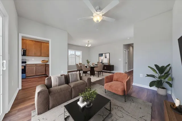 a living room with furniture potted plant and a window