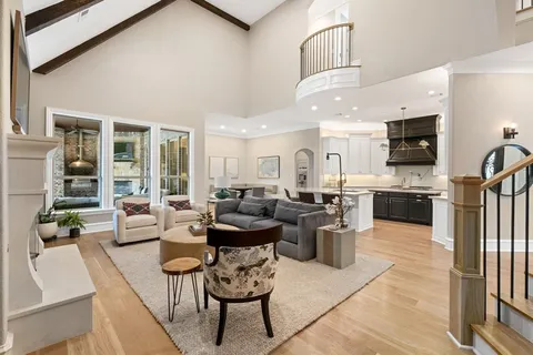 a living room with lots of furniture and kitchen view