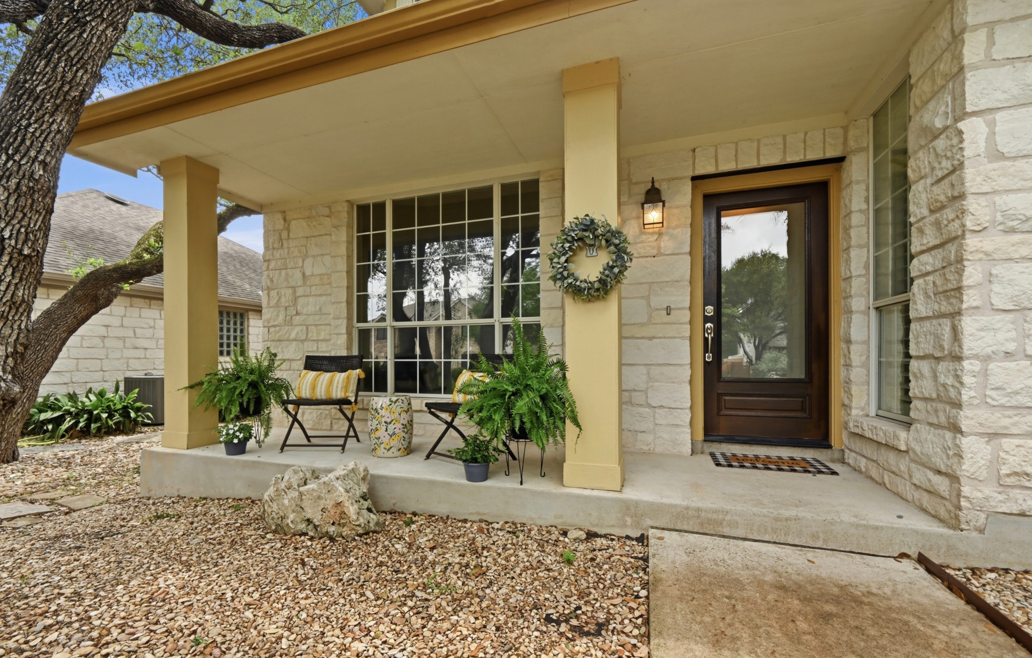 5313 Moon Shadow Drive Austin, TX 78735 - Photo 3 of 30 Stone-clad exterior featuring a covered front porch with substantial columns