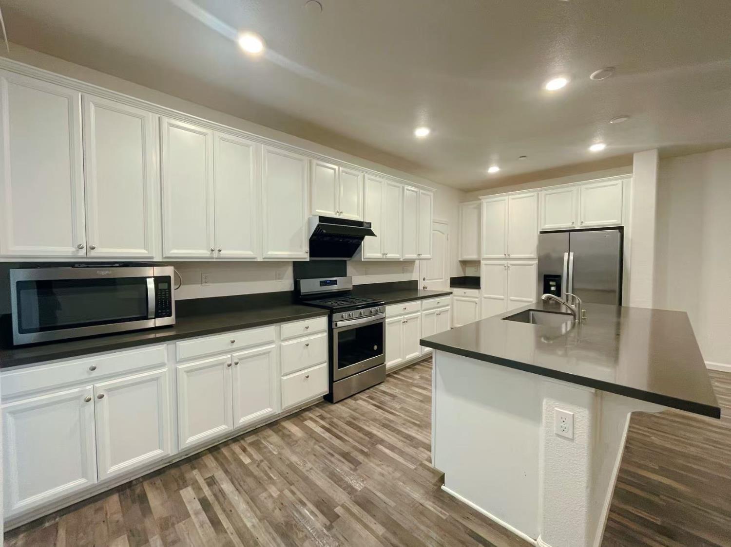 3781 Samuelson Way Sacramento, CA 95834 - Photo 14 of 42 a kitchen with sink a microwave and cabinets