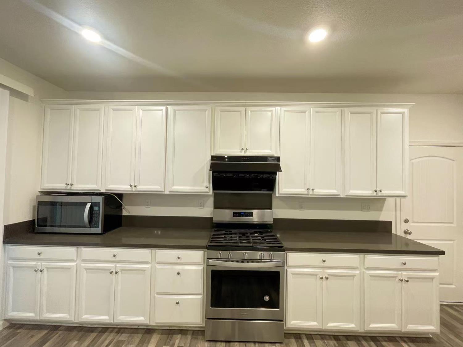 3781 Samuelson Way Sacramento, CA 95834 - Photo 15 of 42 a kitchen with granite countertop white cabinets and stainless steel appliances