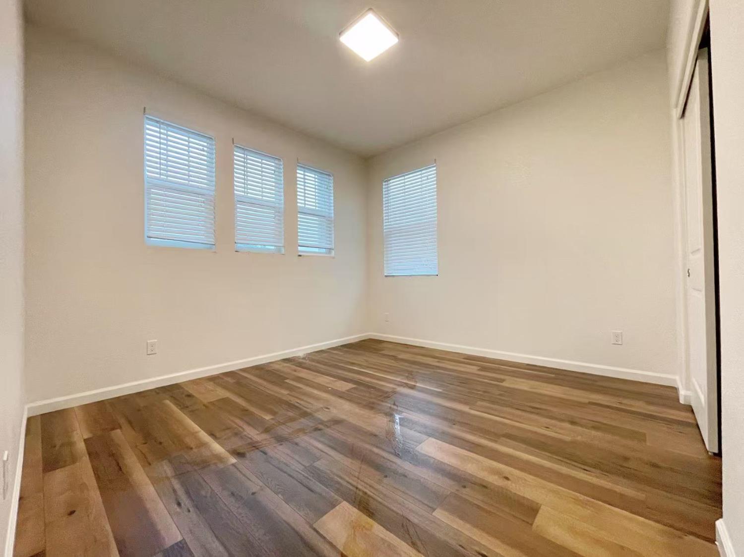3781 Samuelson Way Sacramento, CA 95834 - Photo 23 of 42 a view of empty room with wooden floor and fan
