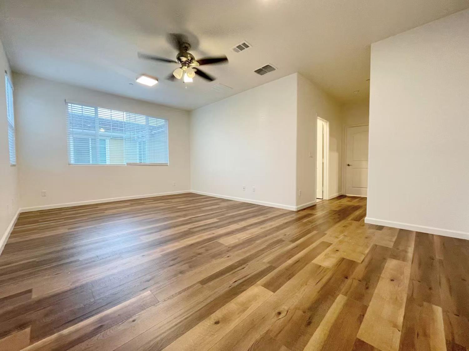 3781 Samuelson Way Sacramento, CA 95834 - Photo 27 of 42 a view of a room with wooden floor and a ceiling fan