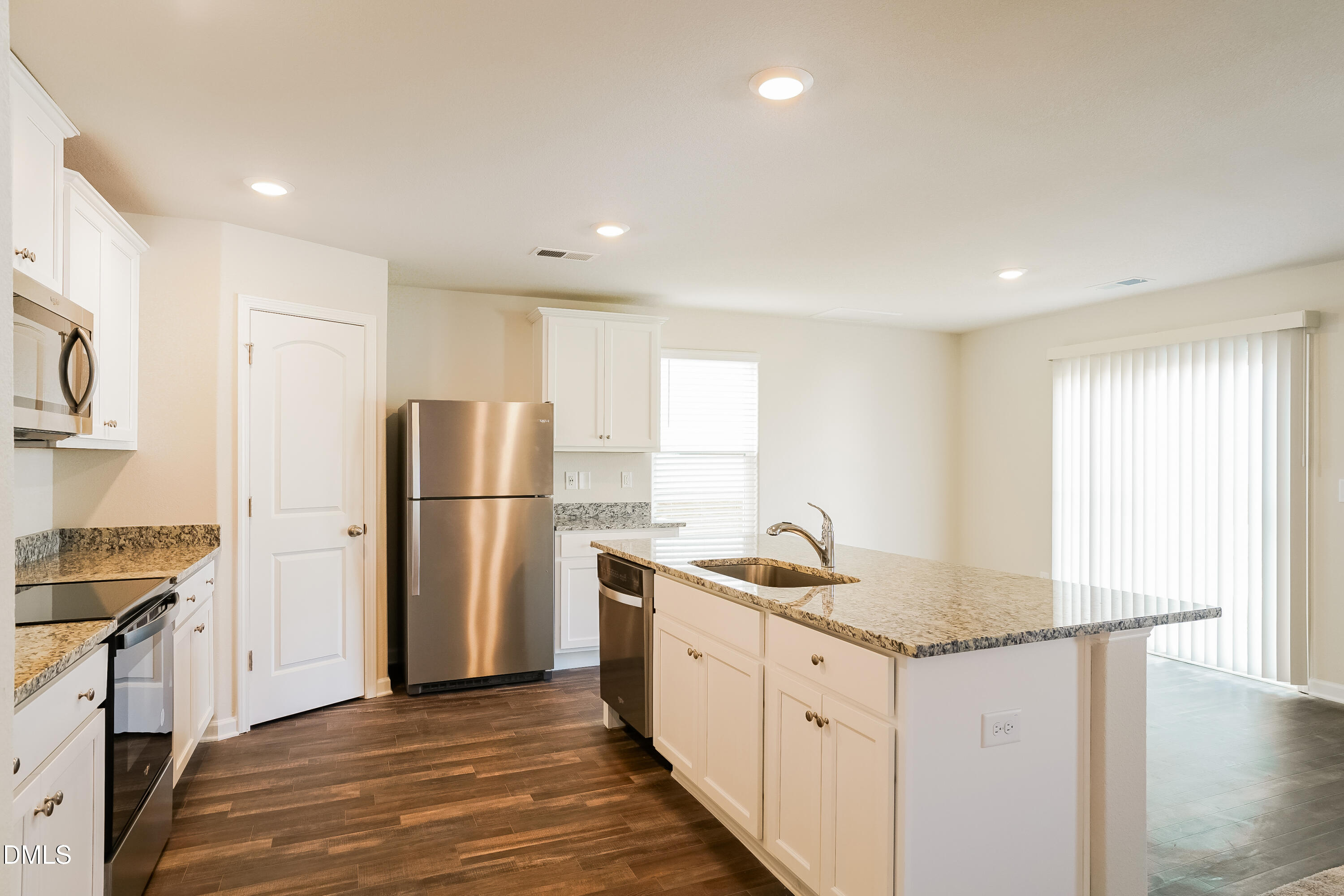 741 Cider Ml Way Zebulon, NC 27597 - Photo 6 of 17 a kitchen with stainless steel appliances granite countertop a refrigerator sink and cabinets