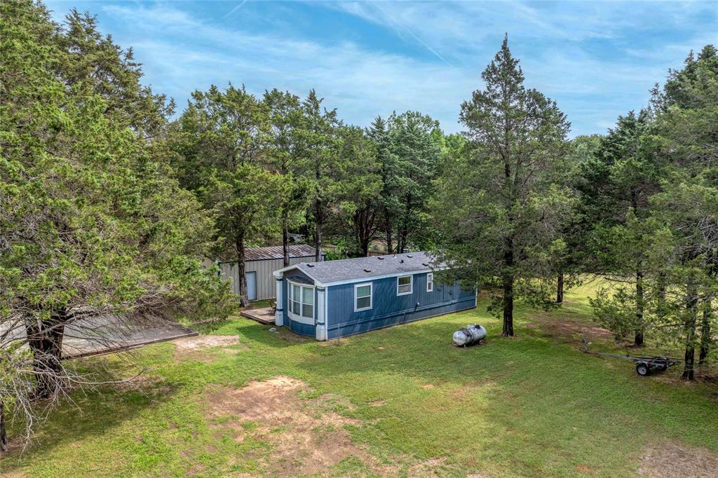 a view of a house with a yard and sitting area